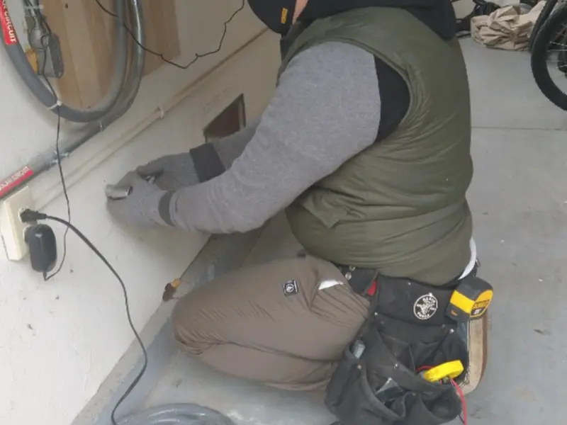 Electrician performing outlet wiring in a Stansbury Park garage