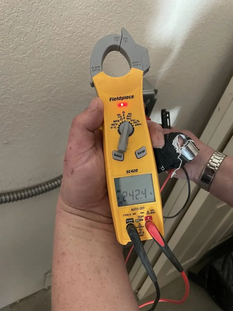 Voltage testing with clamp meter during Outlet Installation in Stansbury Park